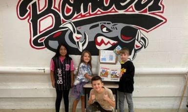  Students collecting Little Bites wrappers. 